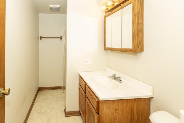 bathroom featuring toilet and vanity