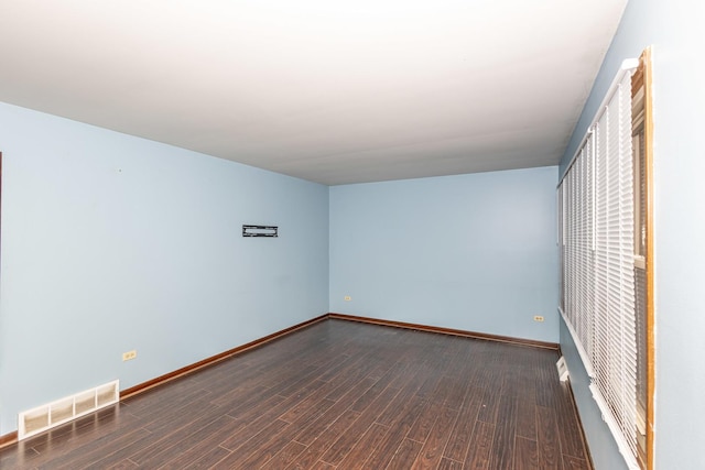 spare room featuring dark hardwood / wood-style floors