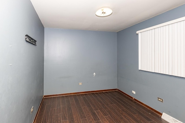 spare room featuring dark hardwood / wood-style floors