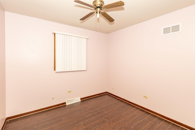 spare room featuring ceiling fan and dark wood-type flooring