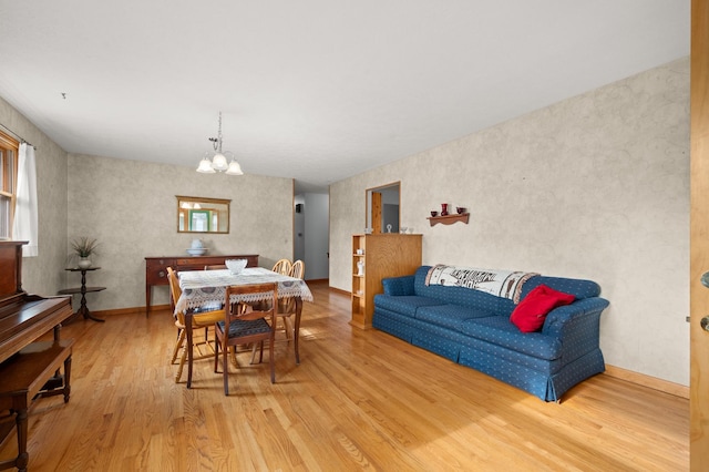 dining space featuring hardwood / wood-style flooring and an inviting chandelier