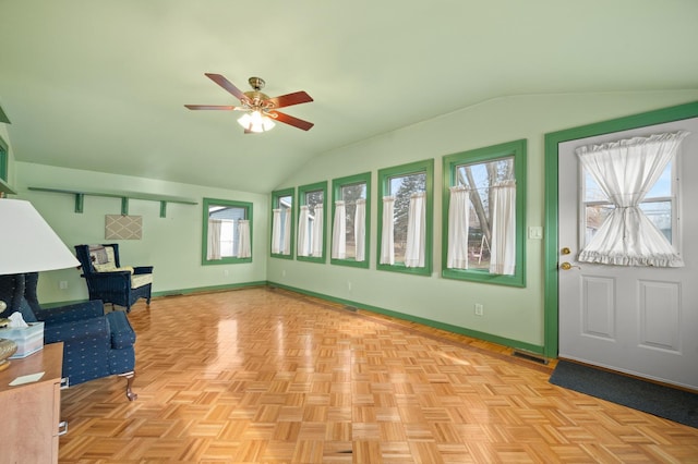 interior space with ceiling fan and lofted ceiling