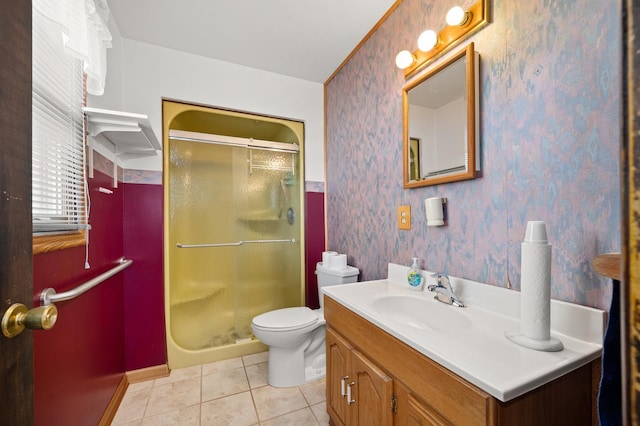 bathroom featuring tile patterned floors, vanity, toilet, and a shower with shower door