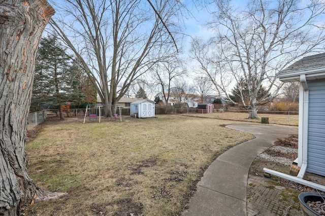 view of yard featuring a shed and a playground