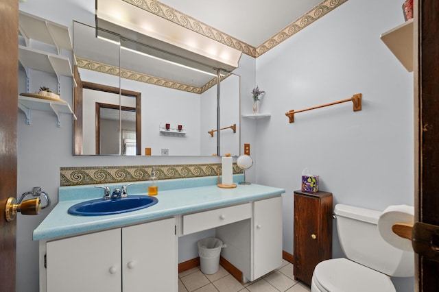 bathroom featuring tile patterned floors, vanity, and toilet