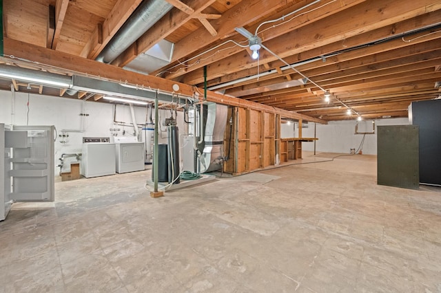 basement featuring washer and clothes dryer and gas water heater