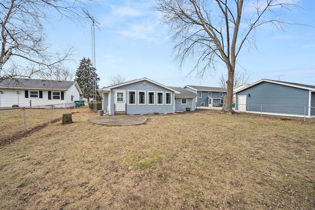 back of house featuring a lawn and a patio area