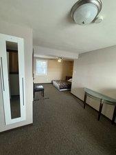 bedroom with dark hardwood / wood-style floors and ceiling fan