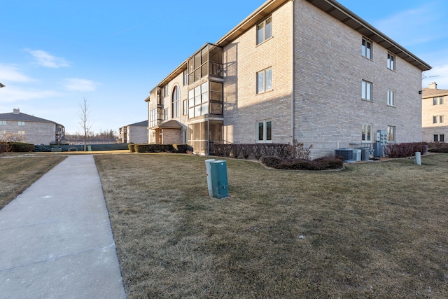 view of home's exterior featuring a garage, central AC unit, and a lawn