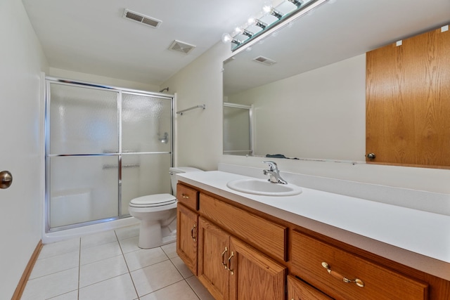 bathroom featuring walk in shower, toilet, tile patterned floors, and vanity