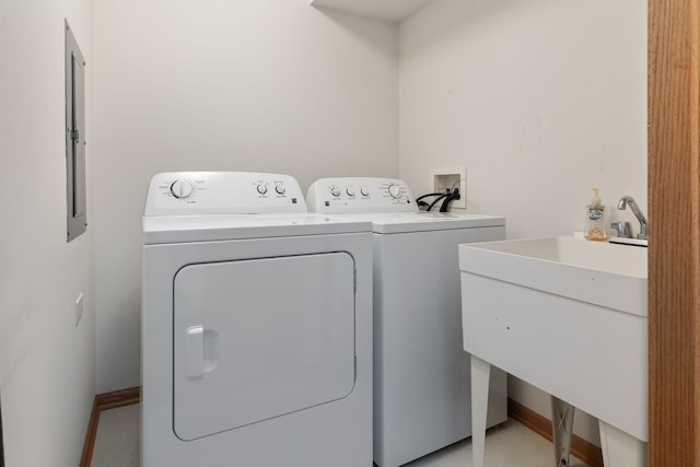 clothes washing area with washer and dryer and sink