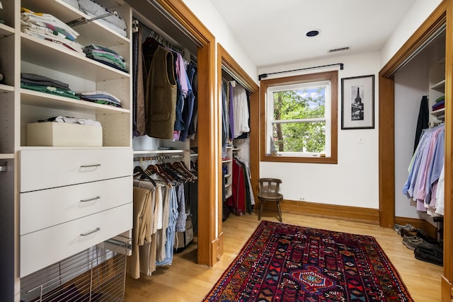 walk in closet with light wood-type flooring