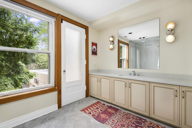 bathroom featuring tile patterned flooring, vanity, and a shower with shower door