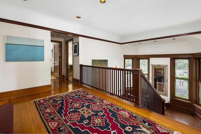 hallway with hardwood / wood-style floors and a wealth of natural light