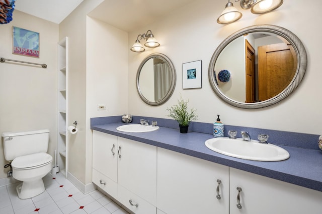 bathroom featuring tile patterned floors, vanity, and toilet