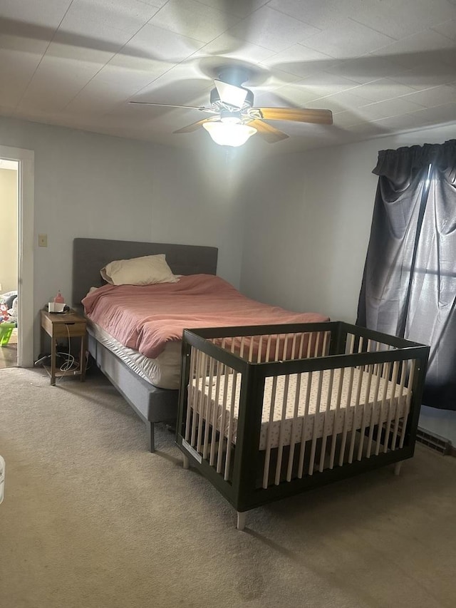 bedroom with ceiling fan and carpet floors