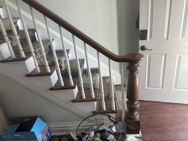 stairs featuring hardwood / wood-style floors