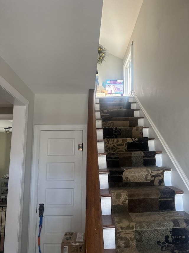 stairway with lofted ceiling