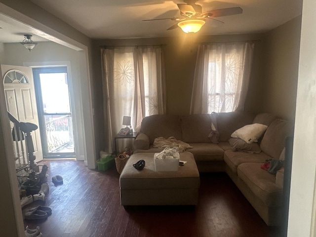 living room featuring ceiling fan, dark hardwood / wood-style floors, and a healthy amount of sunlight