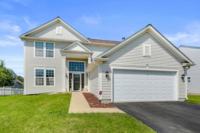 view of front of home with a front lawn and a garage