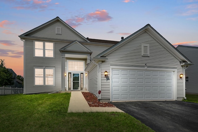 front of property featuring a garage and a lawn