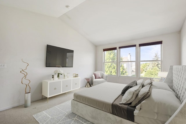 bedroom with light colored carpet and vaulted ceiling