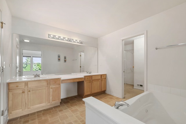 bathroom featuring vanity and a bathing tub