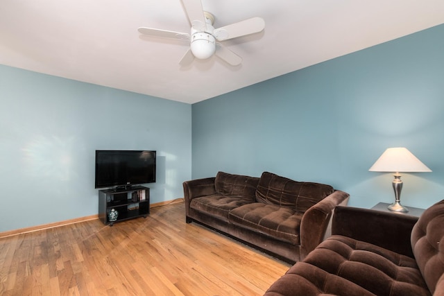 living room with ceiling fan and light hardwood / wood-style flooring