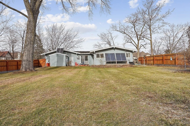 rear view of house with a yard