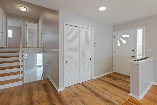 entrance foyer with a wealth of natural light and hardwood / wood-style flooring