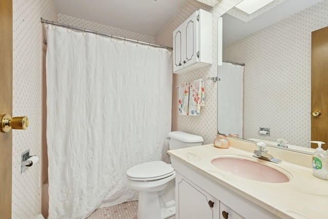 bathroom featuring tile patterned flooring, vanity, and toilet