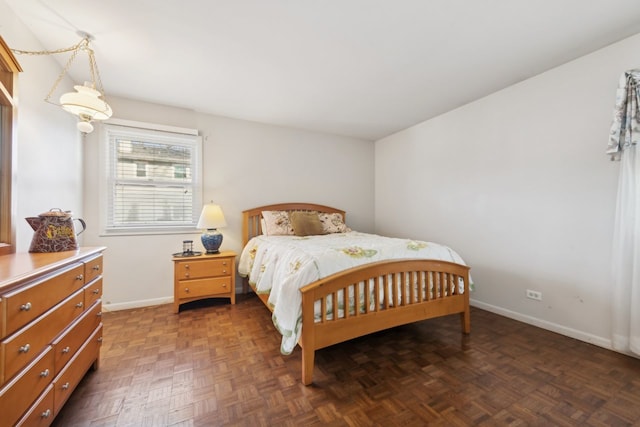 bedroom with dark parquet flooring