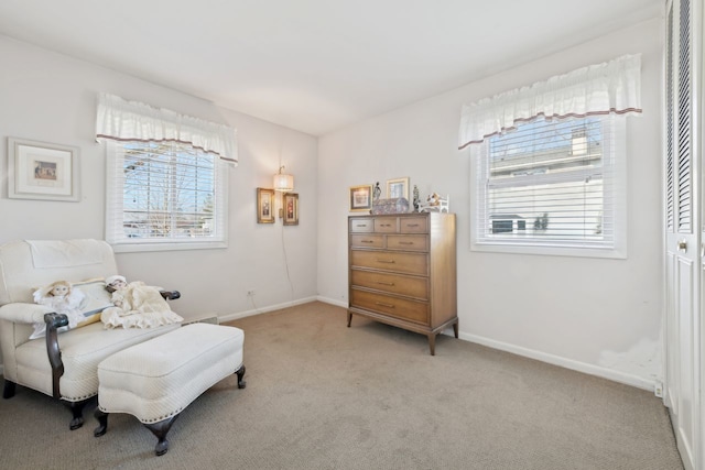 living area featuring light carpet and plenty of natural light