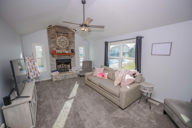 carpeted living room with ceiling fan, a fireplace, and lofted ceiling