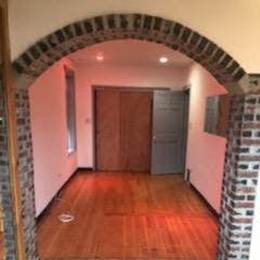 corridor with dark hardwood / wood-style flooring