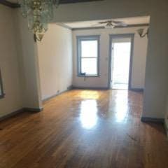 unfurnished room with dark wood-type flooring