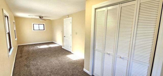 hall featuring dark colored carpet