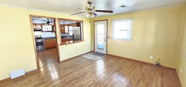 interior space with ceiling fan and light hardwood / wood-style floors