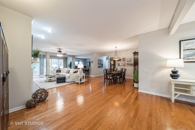 dining space with light hardwood / wood-style floors and ceiling fan