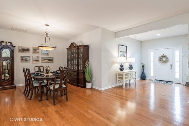 living room featuring a tile fireplace, hardwood / wood-style flooring, and ceiling fan