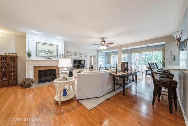 living room with ceiling fan and light hardwood / wood-style floors