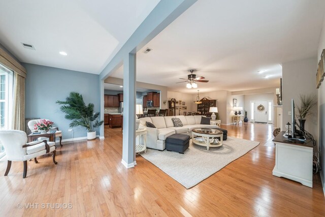 living room with light wood-type flooring and ceiling fan