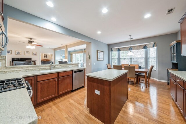 kitchen featuring decorative backsplash, stainless steel fridge, and light wood-type flooring