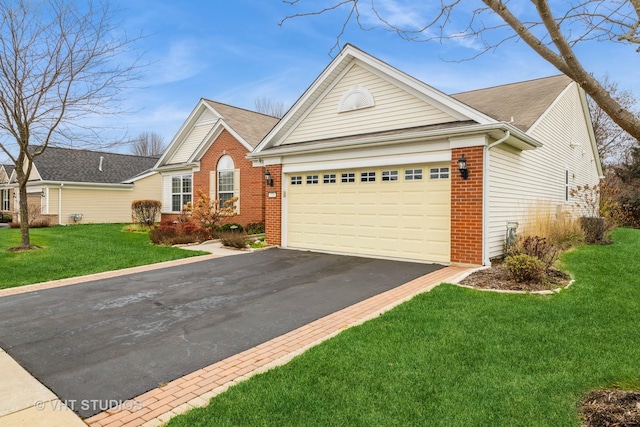 view of front of property with a front yard and a garage