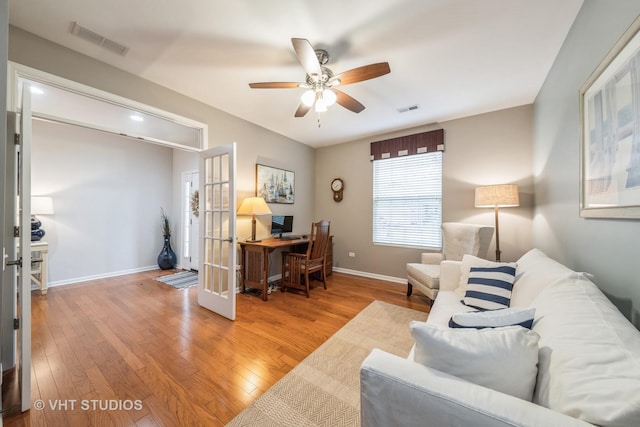 living room featuring ceiling fan and hardwood / wood-style floors