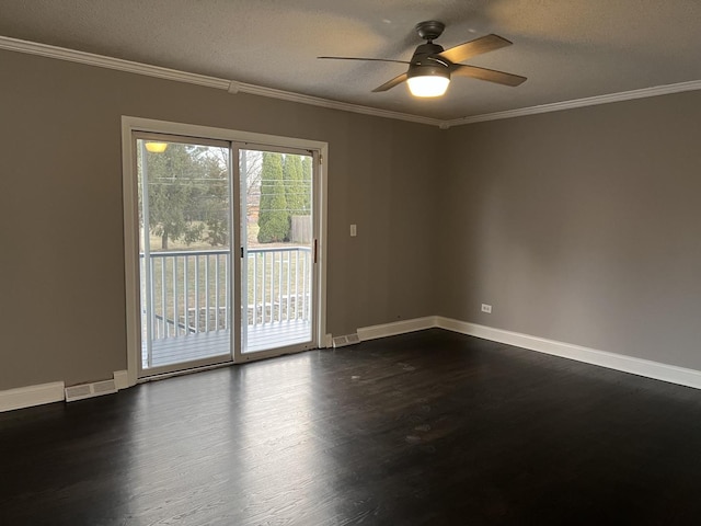 empty room featuring a textured ceiling, dark hardwood / wood-style floors, ceiling fan, and ornamental molding