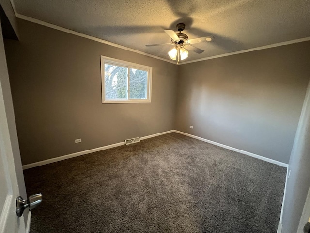 unfurnished room with ceiling fan, dark carpet, a textured ceiling, and ornamental molding