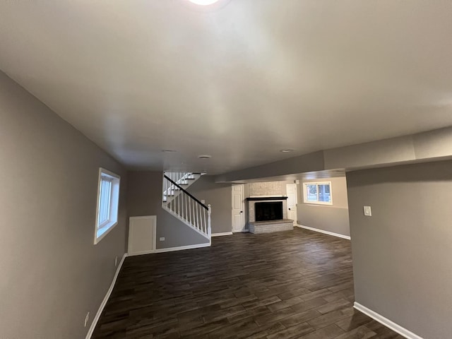 unfurnished living room featuring a fireplace and dark hardwood / wood-style flooring