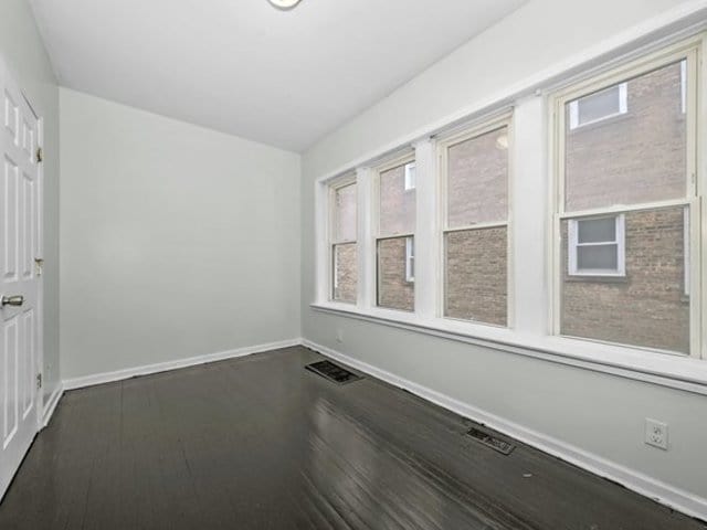 spare room with dark hardwood / wood-style flooring