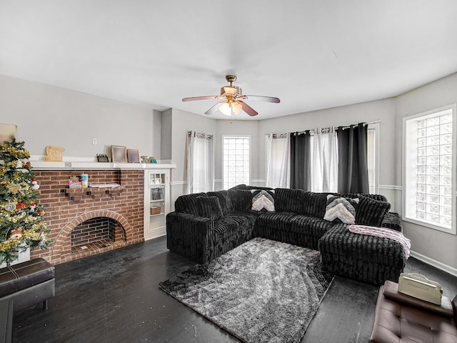 living room with a fireplace, dark hardwood / wood-style flooring, and ceiling fan